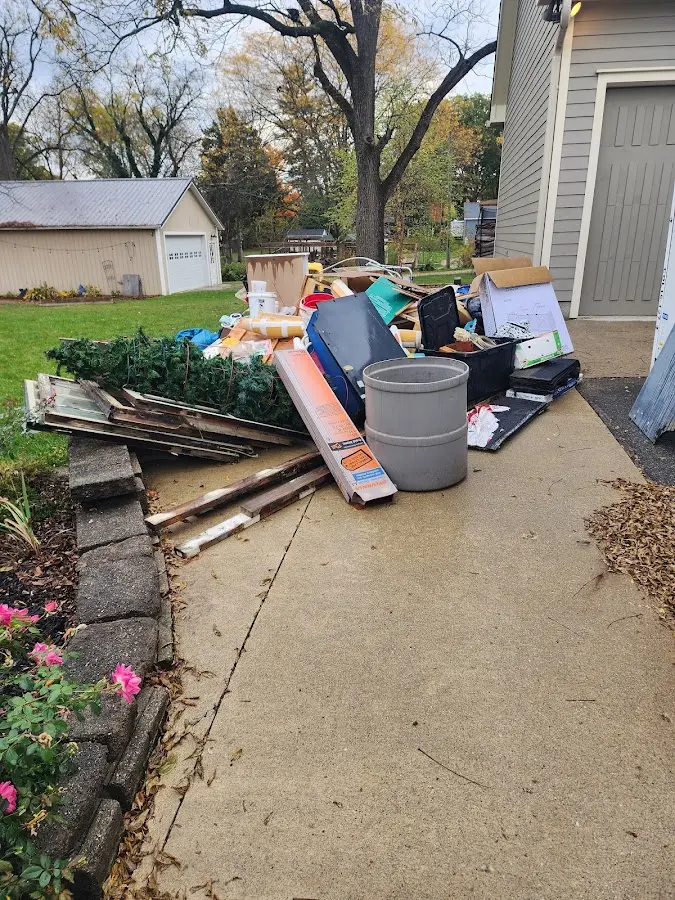 Dumpster being loaded with debris for Roofing Dumpster Rental in Swansboro